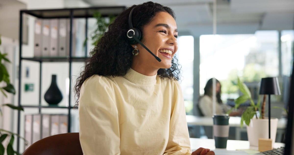 Laughing, happy woman and customer service in call center