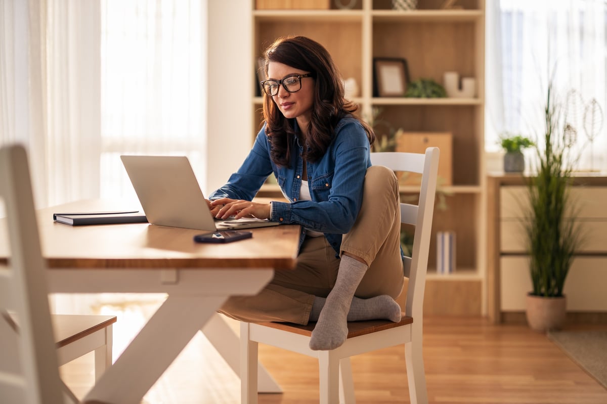 Professional virtual assistant working remotely on laptop in modern home office